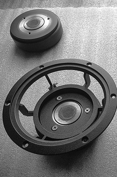 Cast alluminium frame of speaker system drivers.